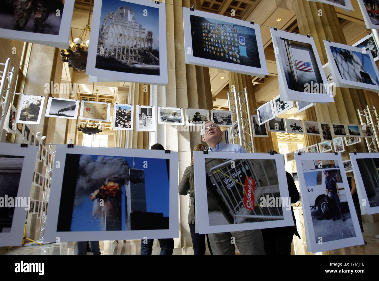 A Man Looks At Photographs That Were Taken Around The Time