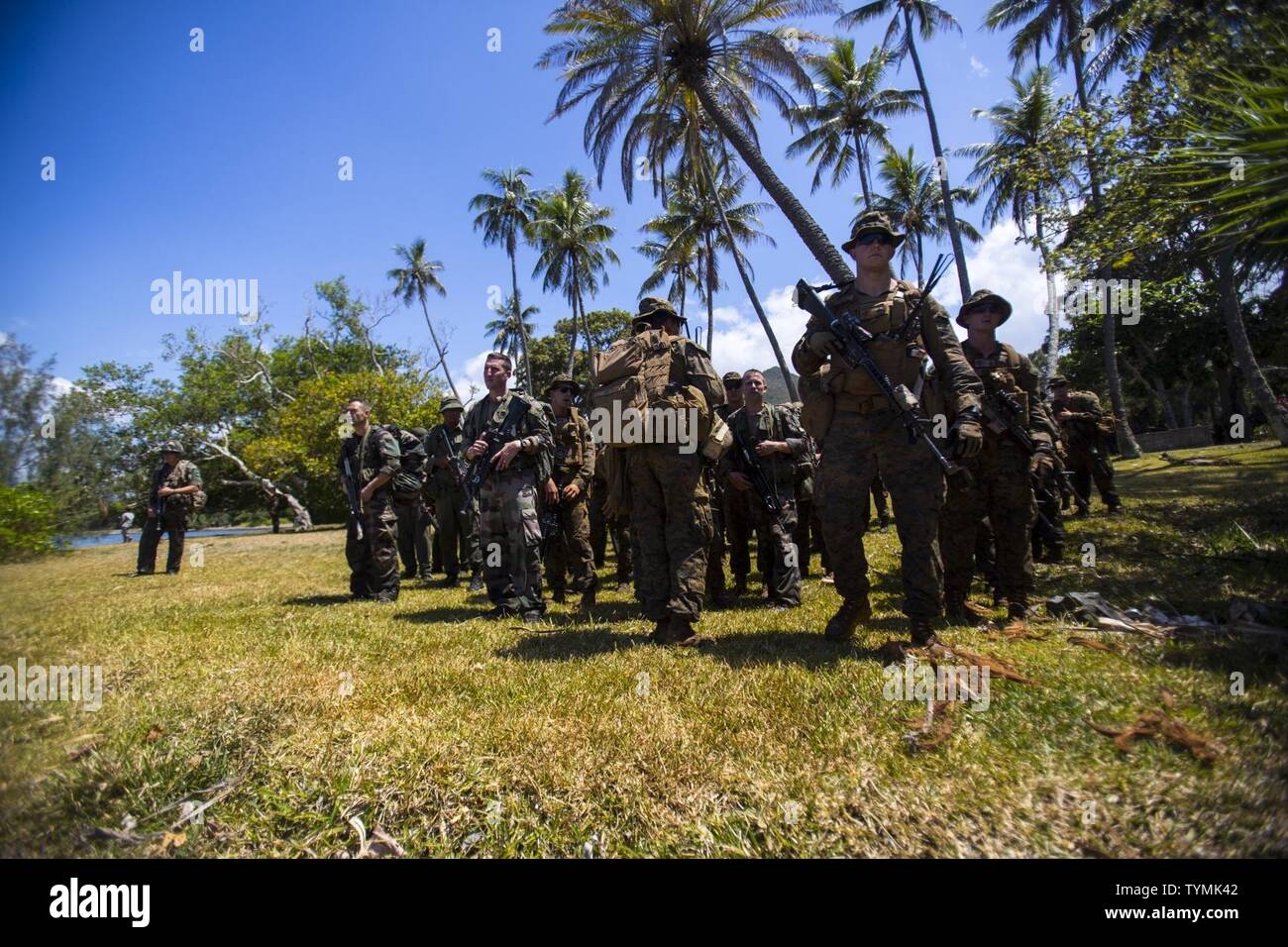 U.S. Marines with Task Force Koa Moana 16-4, French army service members, and the Republic of Fiji Military Forces prepare to load onto an amphibious assault boat during Croix Du Sud in Plum, New Caledonia, Nov. 16, 2016. Croix Du Sud is a multi-national, humanitarian assistance disaster relief and non-combatant evacuation operation exercise conducted every two years to prepare nations in the event of a cyclone in the South Pacific. The Koa Moana exercise seeks to enhance senior military leader engagements between allied and partner nations in the Pacific with a collective interest in military Stock Photo