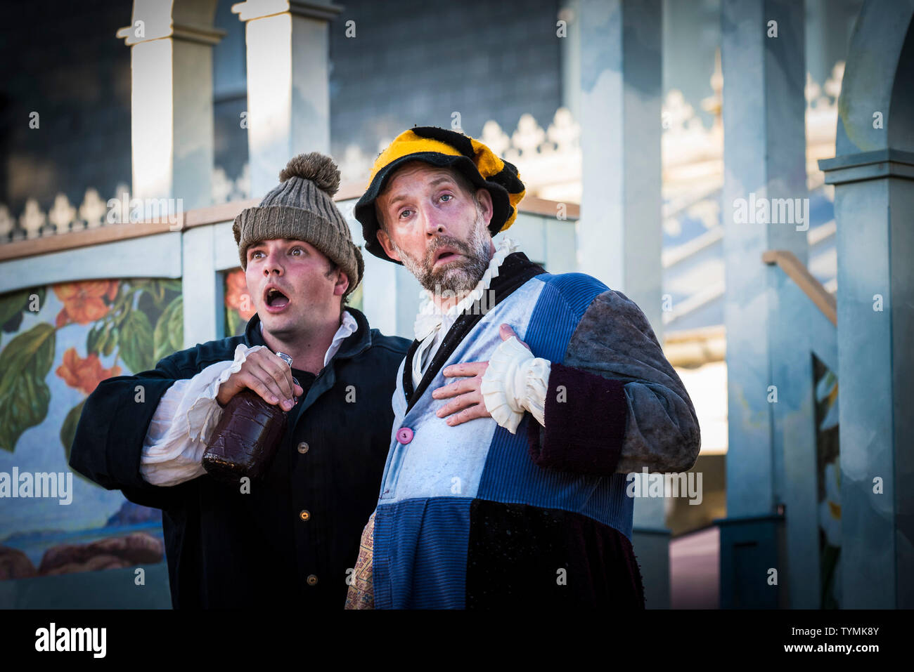 Actors Chris Wills, David Sayers performing the roles of Caliban and Stephano in an outdoor theatre production of The Tempest by Illyria Theatre in Fa Stock Photo