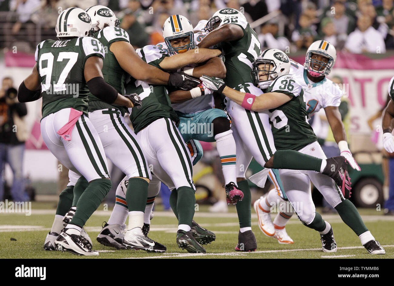 New York Jets David Harris grabs the jersey of New York Giants Eli Manning  and sacks him for a 5 yard loss in the first quarter in week 16 of the NFL