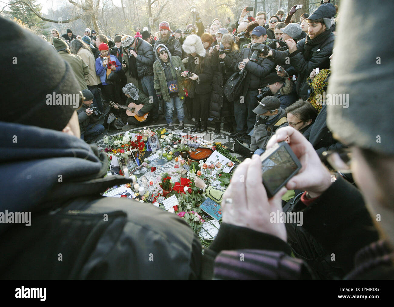 John Lennon fans crowd around the "Imagine" mosaic at Strawberry Fields