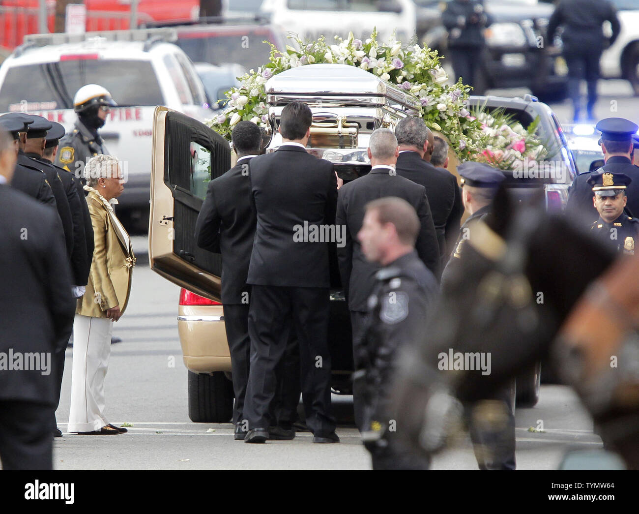 A casket containing the body of Whitney Houston is lifted into a gold hearse  from The New Hope Baptist Church at the Funeral of Whitney Houston in  Newark, New Jersey on February
