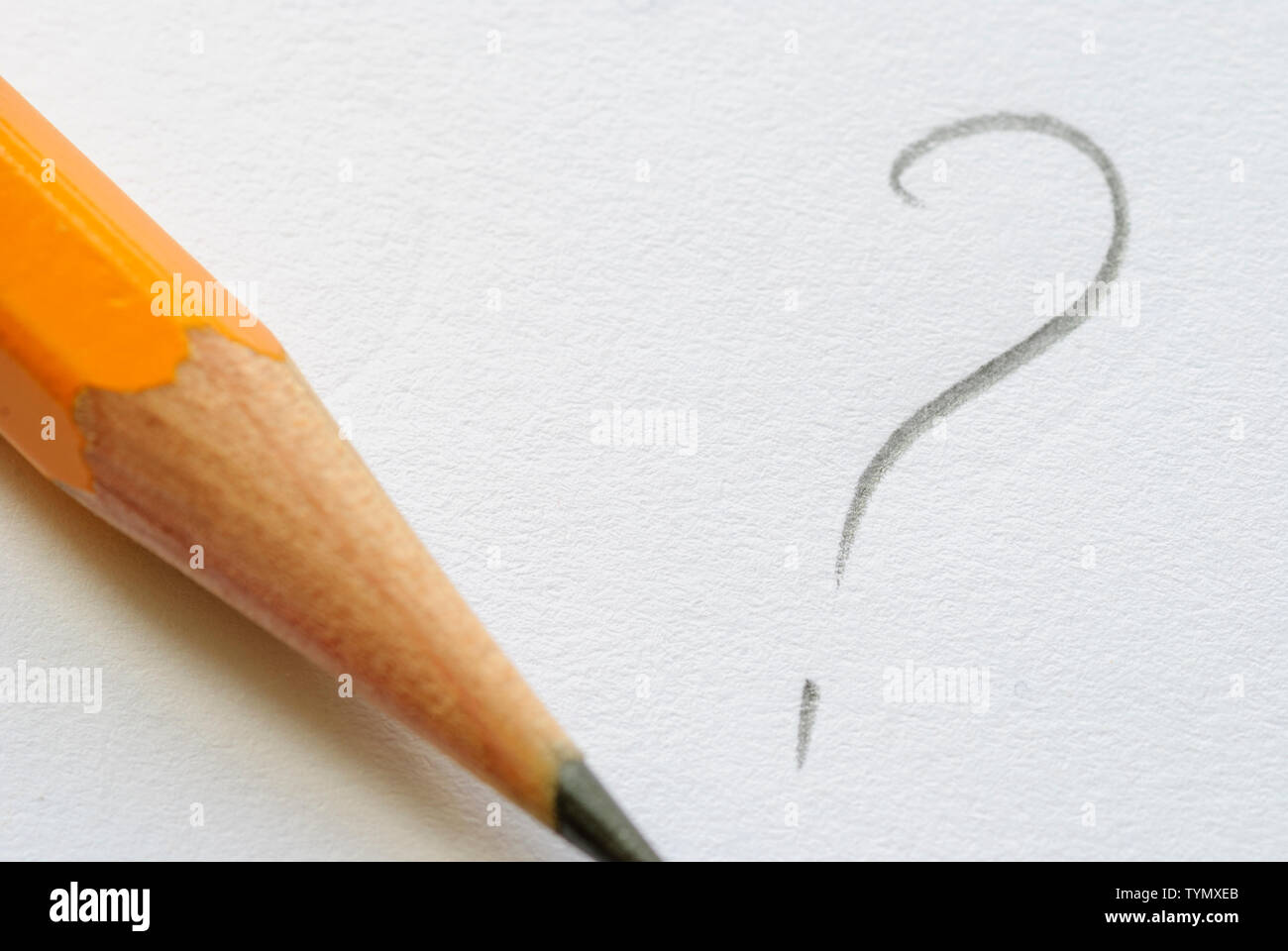 Pencil and written question mark on white paper and copy space Stock
