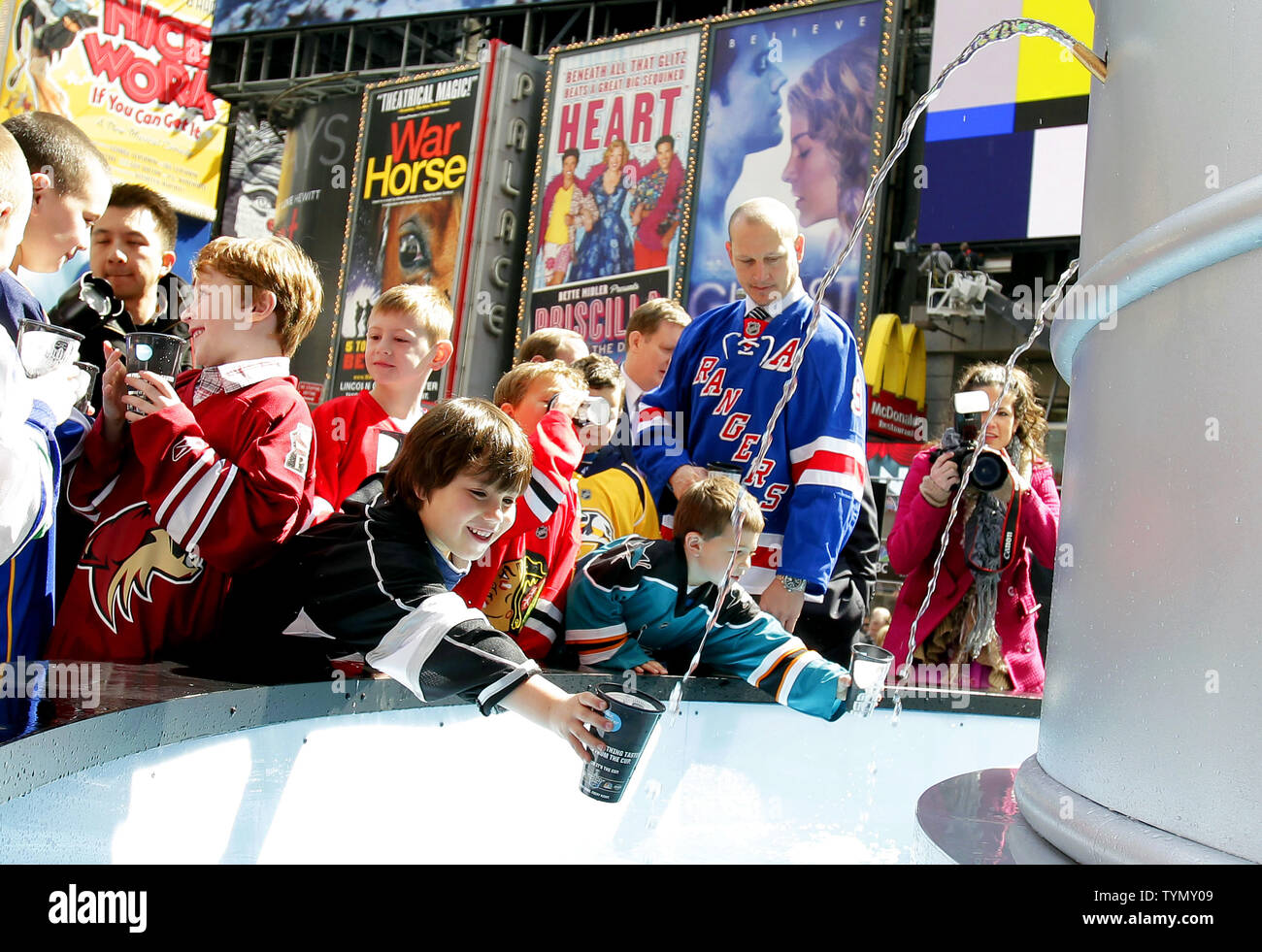 https://c8.alamy.com/comp/TYMY09/former-new-york-rangers-player-adam-graves-watches-kids-drink-from-a-21-foot-6600-pound-replica-of-the-stanley-cup-in-times-square-in-new-york-city-on-april-11-2012-the-stanley-cup-replica-also-serves-as-a-working-fountain-so-nhl-fans-can-drink-from-the-famous-trophy-upijohn-angelillo-TYMY09.jpg