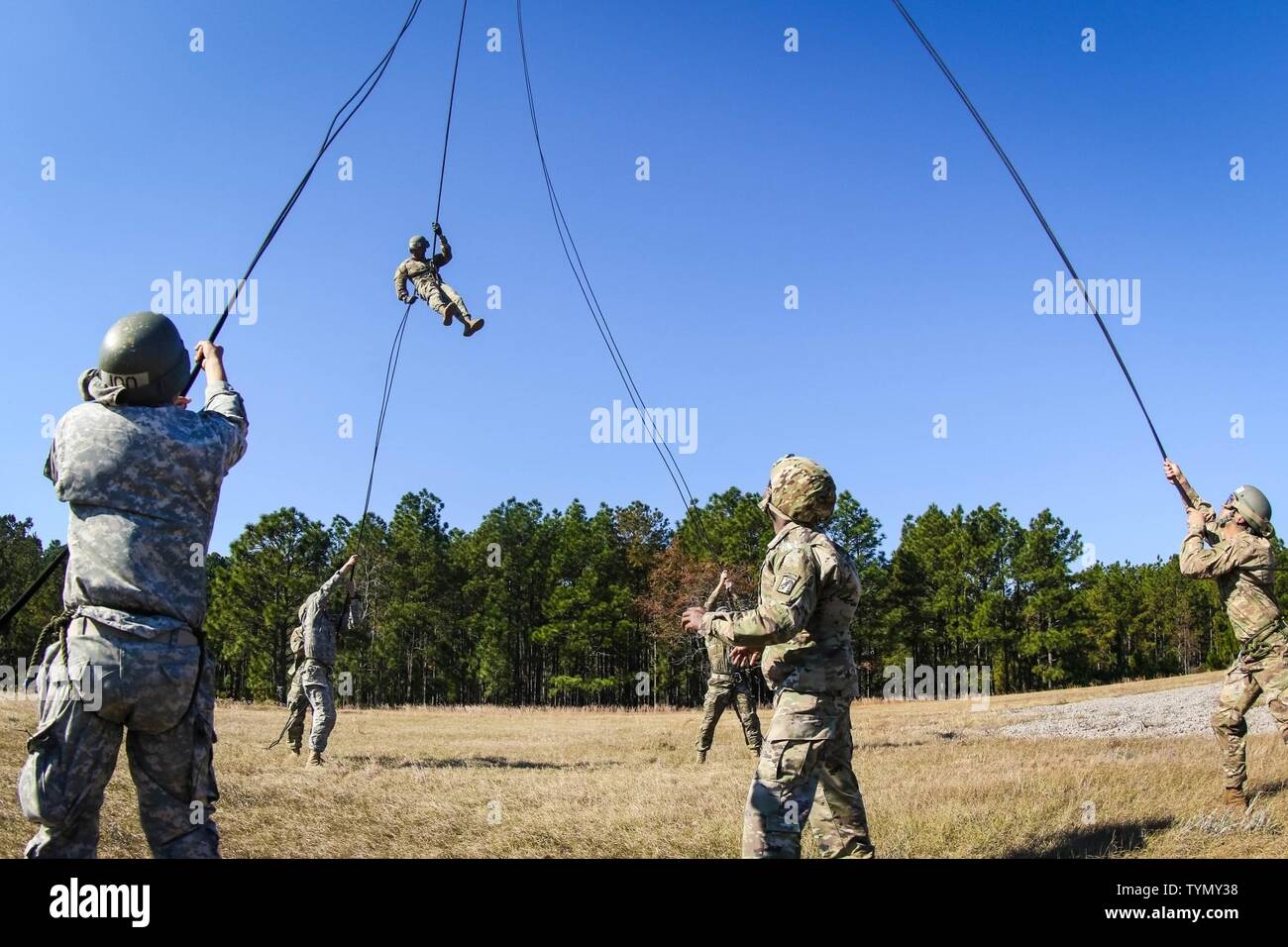 Two instructors and four students from the DeGlooper Air Assault School, VXIII Airborne Corps, wait as classmates rappel from an UH-60 Black Hawk assigned to 2nd Assault Helicopter Battalion, 82nd Combat Aviation Brigade, 82nd Airborne Division at Fort Bragg, N.C., Nov. 17. Stock Photo