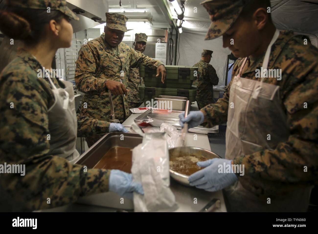 An inspector for the W.P.T. Hill award gives a suggestion to a Marine