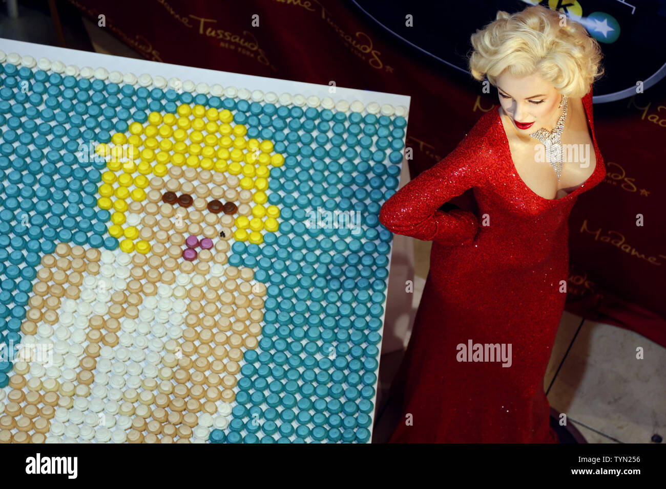 A one-of-a-kind 8 x 4 foot portrait of Marilyn Monroe made from 2,100 bite sized stuffed cupcakes stands in the lobby next to her wax figure on the eve of Marilyn Monroe's 86th birthday at Madame Tussauds in New York City on May 31, 2012.       UPI/John Angelillo Stock Photo