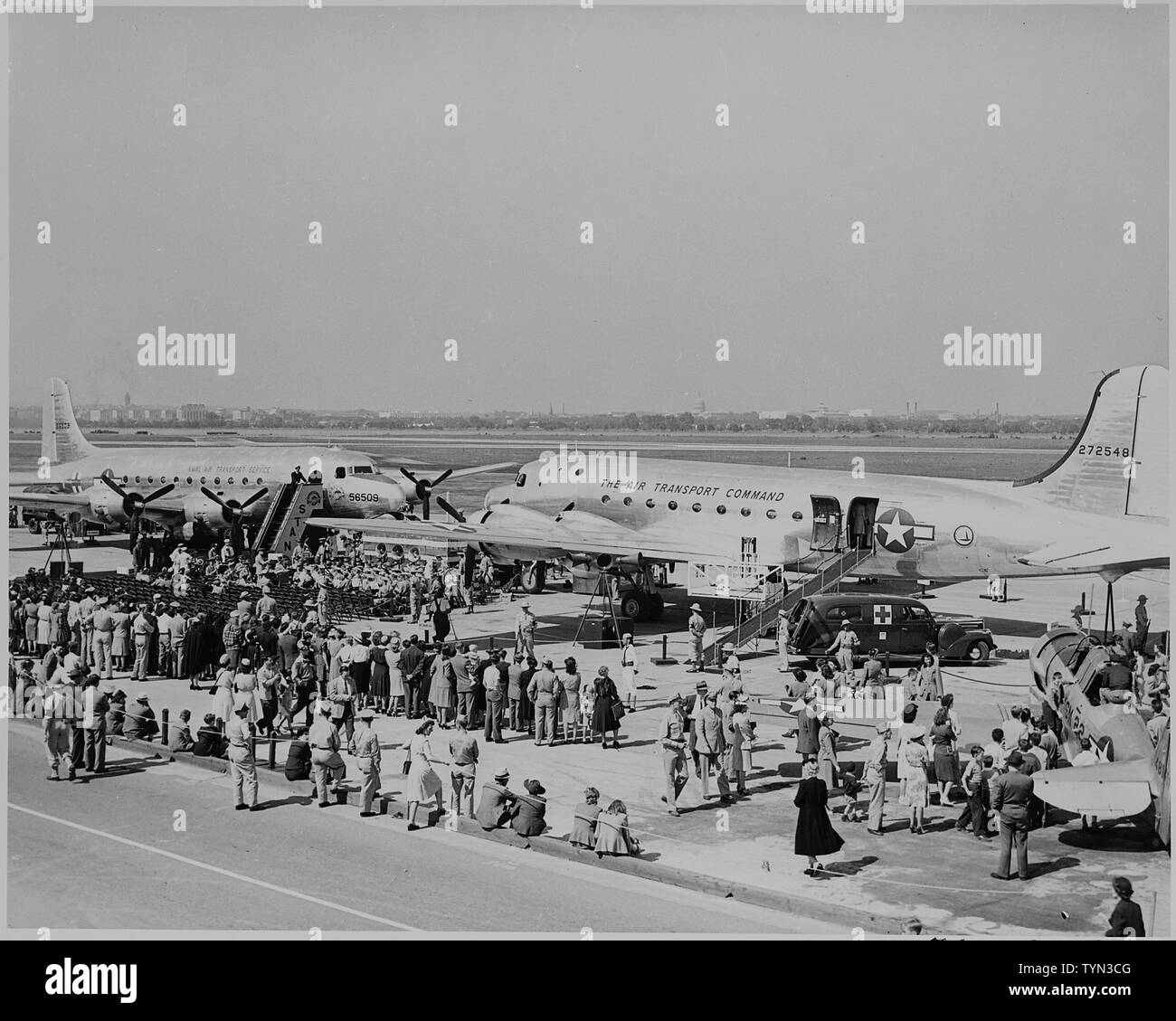 Two airplanes and a crowd gathered for the christening by Bess Truman