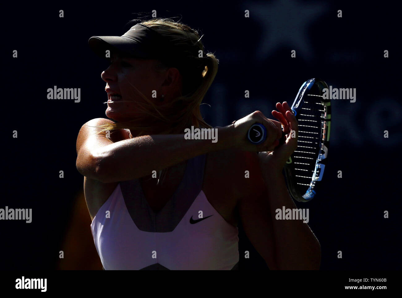 Maria Sharapova of Russia hits a forehand in her match against Mallory