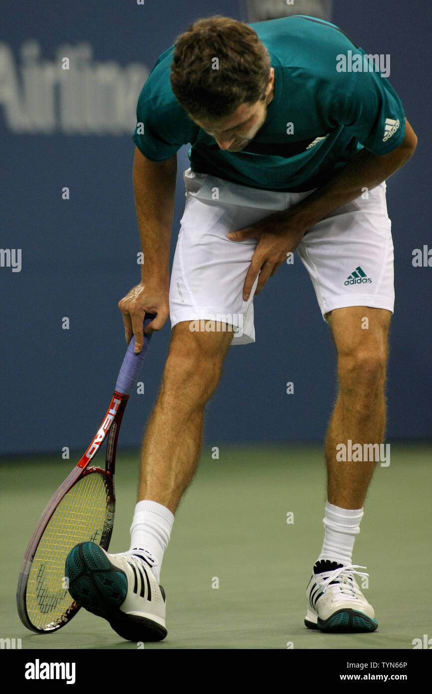 Gilles Simon, France, stretches his leg during his match against Mardy  Fish, USA, during third-round action at the 2012 U.S. Open held at the  National Tennis Center on September 1, 2012. UPI