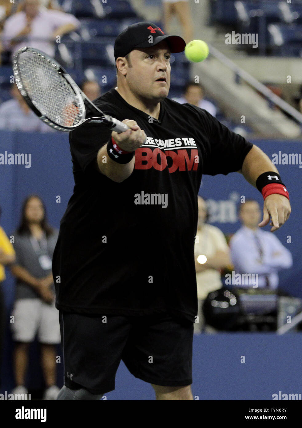 Kevin James hits a forehand in a doubles exhibition match with Adam Sandler, Jim Courier and John McEnroe on day 11 in Arthur Ashe Stadium at the Billie Jean King National Tennis Center in New York City on September 6, 2012.      UPI/John Angelillo Stock Photo