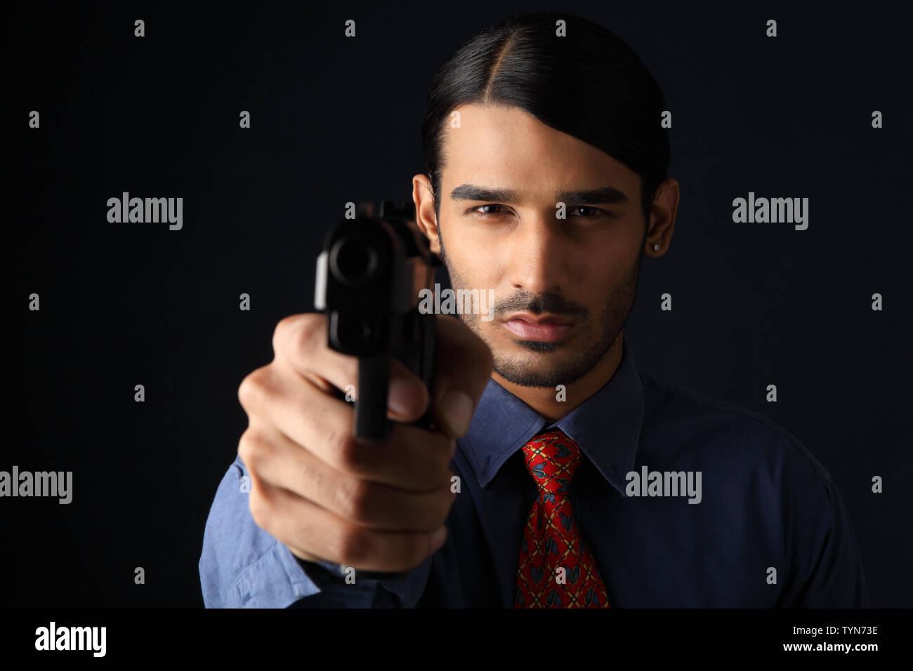 Businessman pointing gun Stock Photo