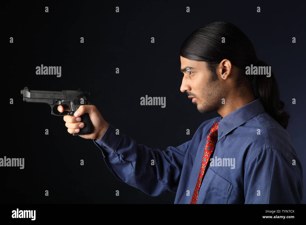 Indian businessman pointing gun Stock Photo
