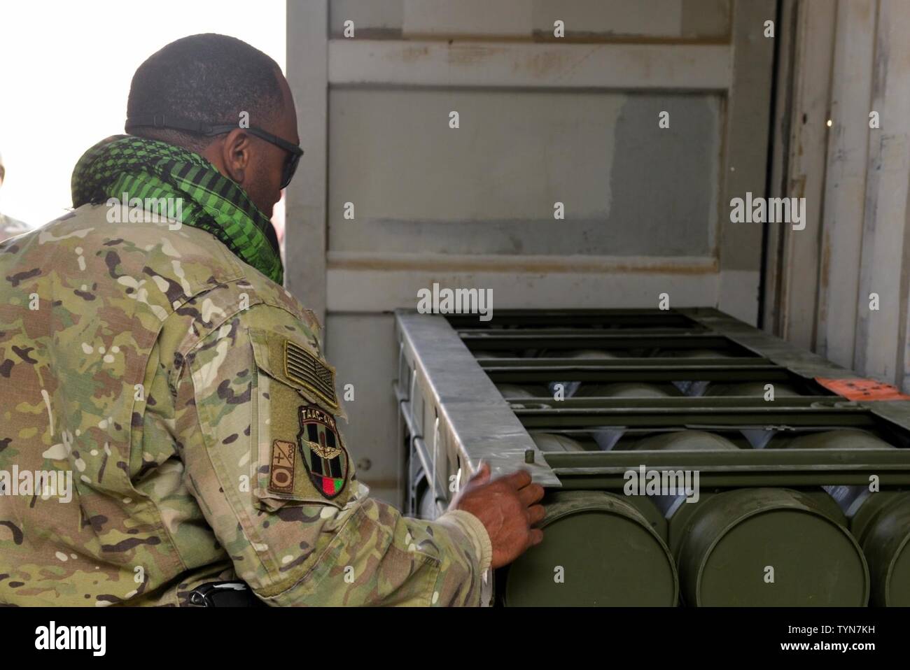 Master Sgt. Rick Page, Train, Advise, Assist Command-Air (TAAC-Air) occupational safety advisor, looks at weapons stored in a facility at Mazar-e-Sharif, Afghanistan, Nov. 17, 2016. Page traveled from Hamid Karzai International Airport to perform a site visit and discuss upcoming munitions field depot construction with the Army Corps of Engineers. Stock Photo