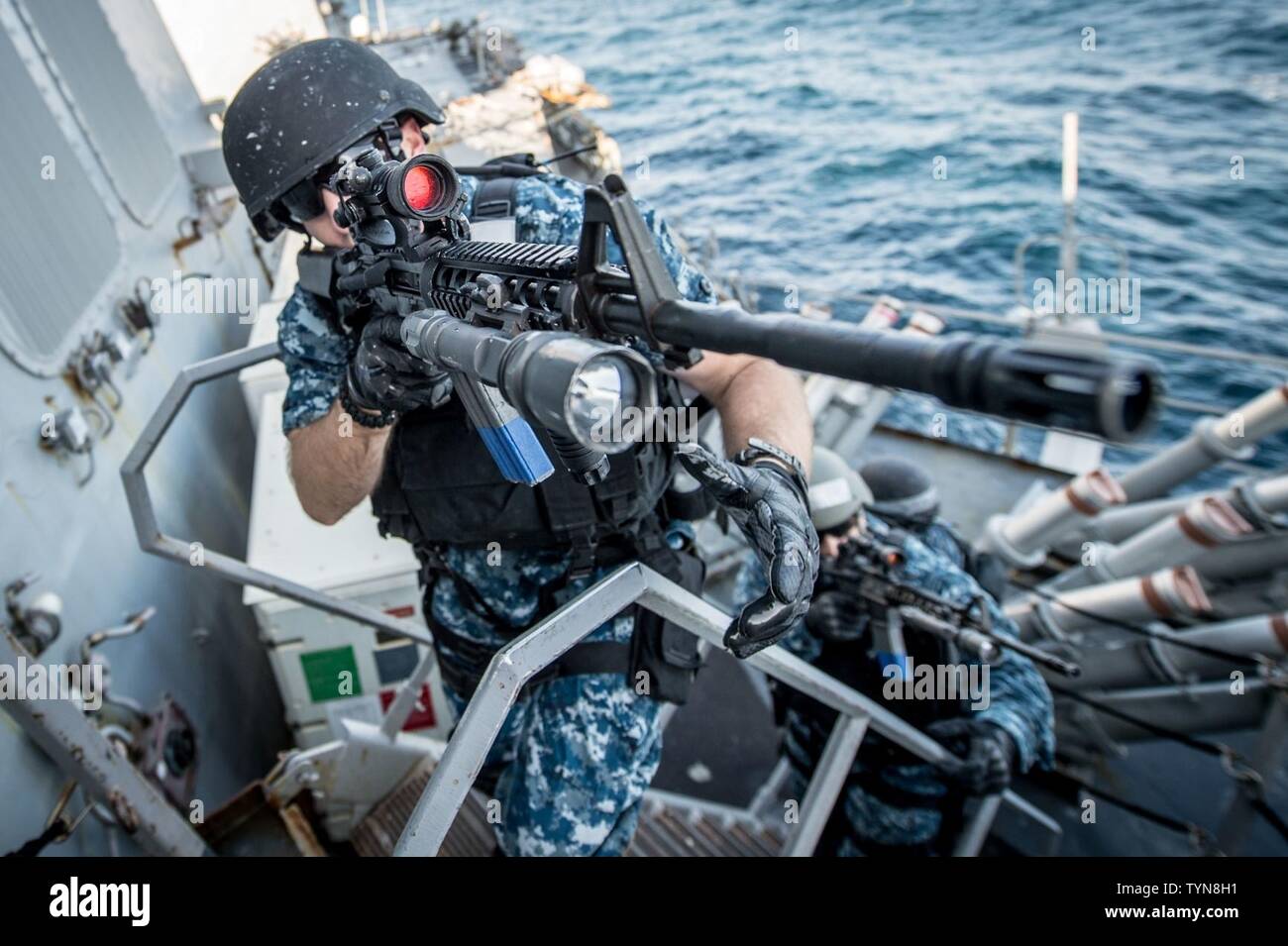 SEA OF JAPAN (Nov. 17, 2016) Petty Officer 2nd Class Ryan A. Green, assigned to the forward-deployed Arleigh Burke-class guided-missile destroyer USS Barry (DDG 52) visit, board, search and seizure (VBSS) team, approaches the pilothouse during a training exercise. Barry is on patrol in the U.S. 7th Fleet area of operations supporting security and stability in the Indo-Asia-Pacific region. Stock Photo