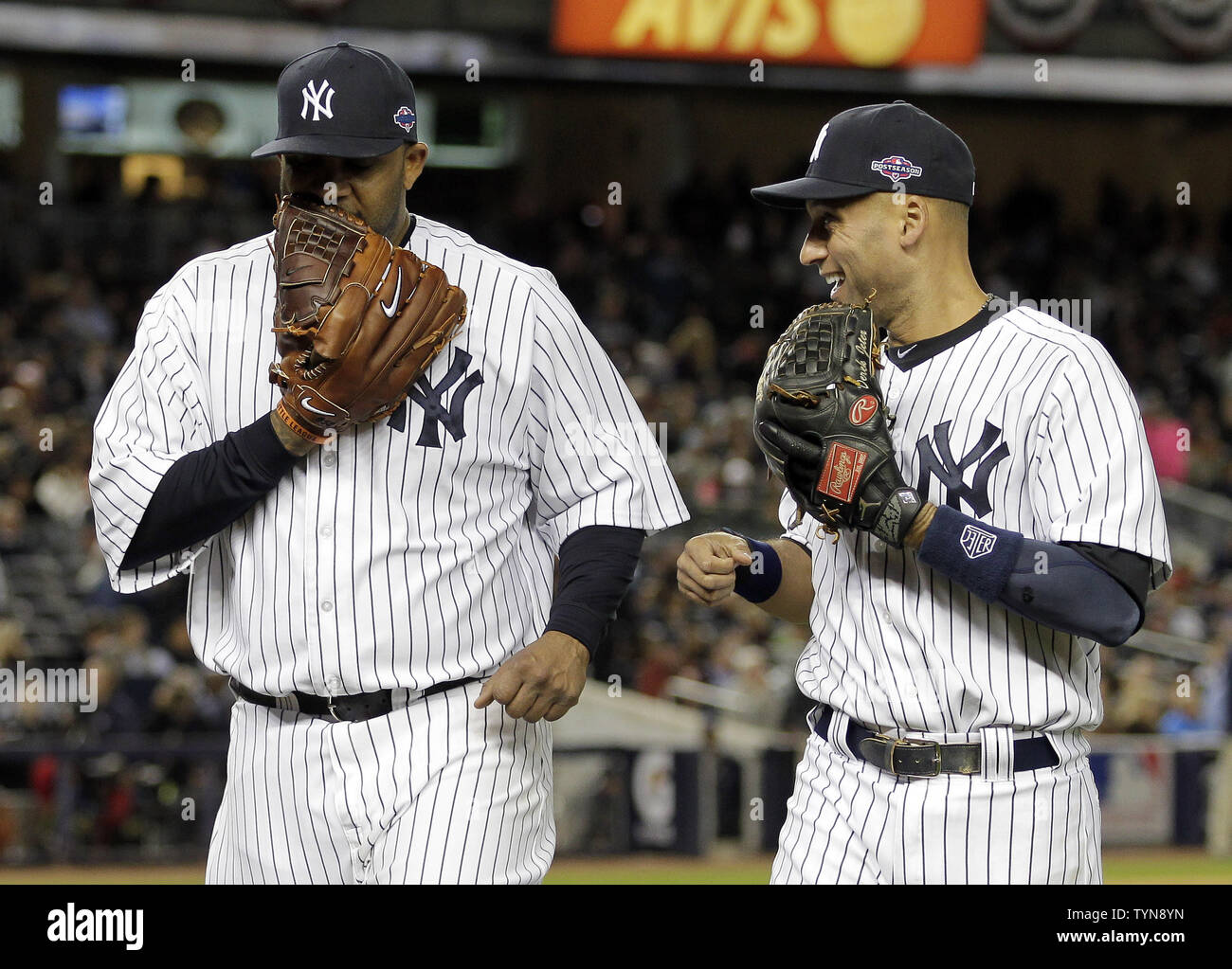 New York Yankees starting pitcher CC Sabathia and Derek Jeter react as they  walk off the field in the seventh inning in game 5 of the ALDS against the  Baltimore Orioles at