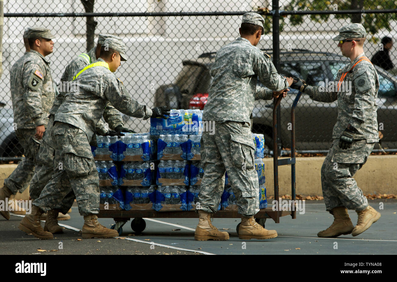 Members of the National Guard bring in bottled water which will be distributed to residents who have been without power in the neighborhood of Chelsea due to Hurricane Sandy on November 2, 2012 in New York City. Hundreds of thousands throughout the eastern seaboard have been without power after the superstorm brought on record storm surges and intense winds.     UPI /Monika Graff Stock Photo