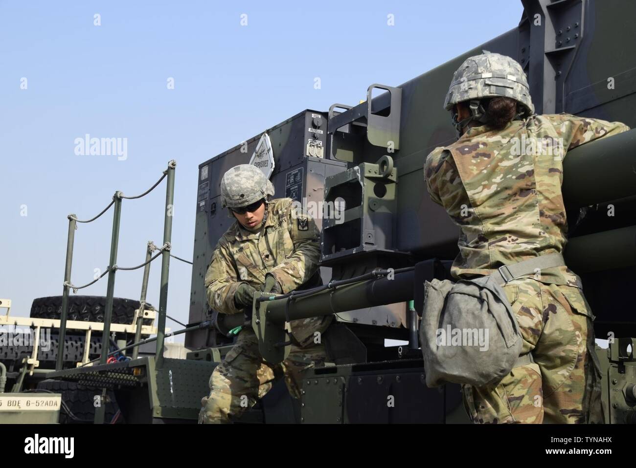 Spc. Henry Laron and Pvt. Jasleen Molina execute march order and emplacement, a combat ready validation test, at Suwon Air Base, Republic of Korea, Nov. 17, 2016. MO&E is a critical test for air defense Soldiers, it demonstrates their proficiency in their assigned duties. Stock Photo