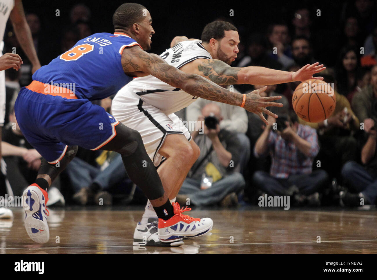 Brooklyn Nets Deron Williams and New York Knicks J.R. Smith reach for a loose ball in the second quarter at the Barclays Center in New York City on December 11, 2012.   UPI/John Angelillo Stock Photo