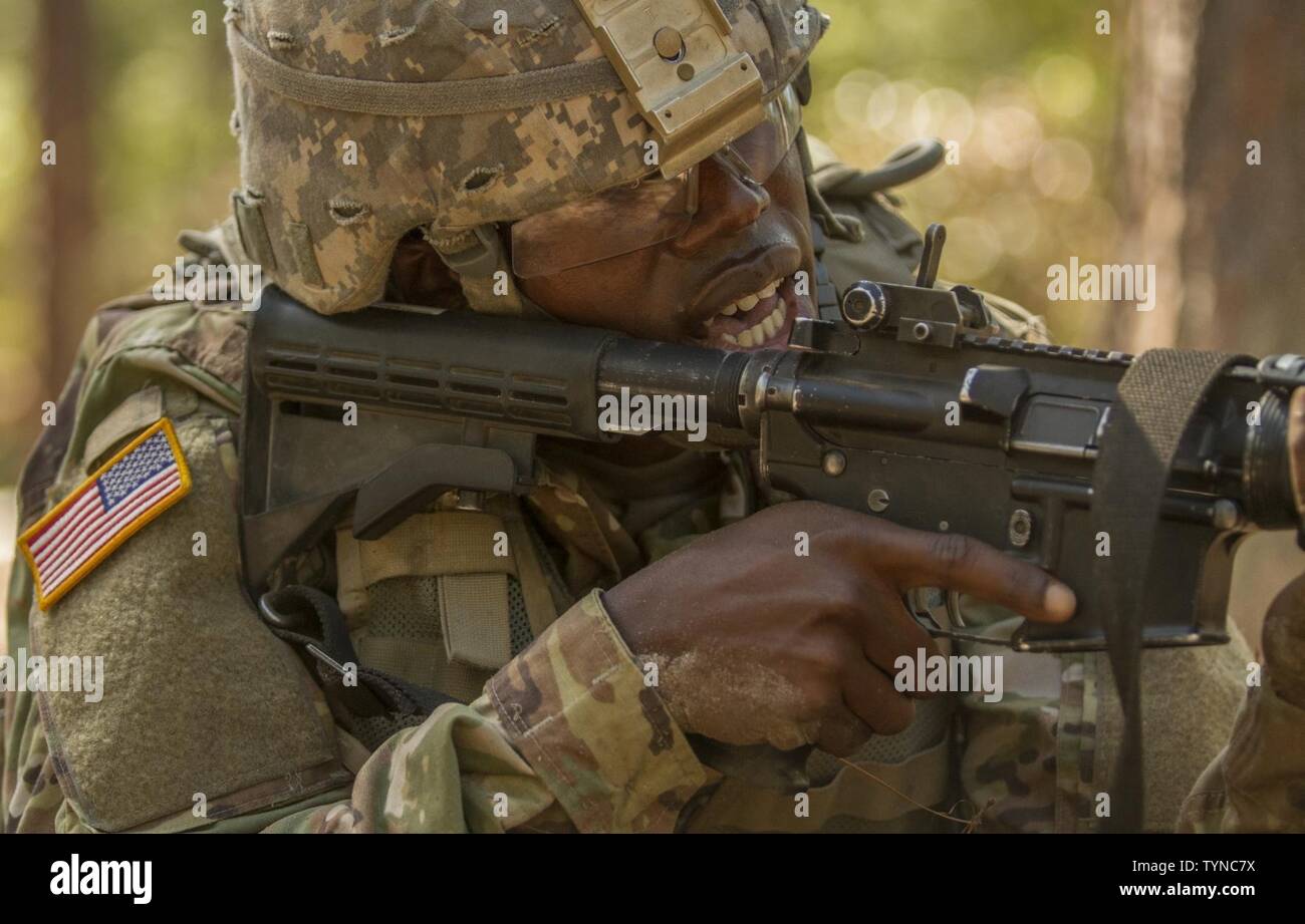 Pvt. Rolando Swaby, an Army Reserve Soldier in basic combat training with Company A, 1st Battalion, 61st Infantry Regiment at Fort Jackson, S.C., takes aim at his target at the hand grenade assault course, Oct. 19. Stock Photo