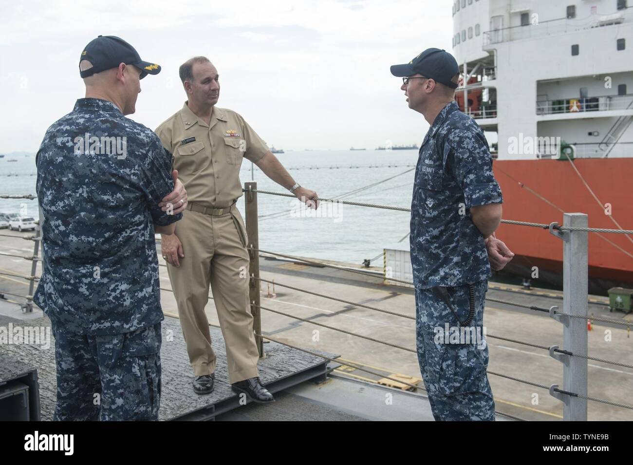 CHANGI NAVAL BASE, Singapore (November 18, 2016) Petty Officer 1st Class Jedediah Lamping explains the addition of the Harpoon missile to Rear Adm. John Weigold, deputy reserve commander, Pacific Fleet, during a tour aboard USS Coronado (LCS 4). Currently on a rotational deployment in support of the Asia-Pacific Rebalance, Coronado is a fast and agile warship tailor-made to patrol the region’s littorals and work hull-to-hull with partner navies, providing 7th Fleet with the flexible capabilities it needs now and in the future. Stock Photo