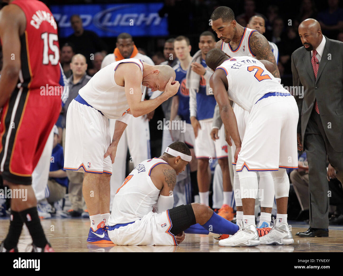 New York Knicks Jason Kidd, J.R. Smith, Raymond Felton and head coach Mike Woodson watch Carmelo Anthony sit on the court after he makes contact with a player from the Miami Heat while shooting a jump shot at Madison Square Garden in New York City on March 3, 2013. The Heat rallied from 16 down to overtake the Knicks 99-93 and match a franchise mark of 14 straight wins.  UPI/John Angelillo Stock Photo
