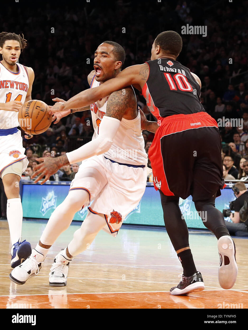 New York Knicks J.R. Smith is fouled by Toronto Raptors DeMar DeRozan in  the fourth quarter at Madison Square Garden in New York City on March 23,  2013. The Knicks defeated the, image size:1045x1390