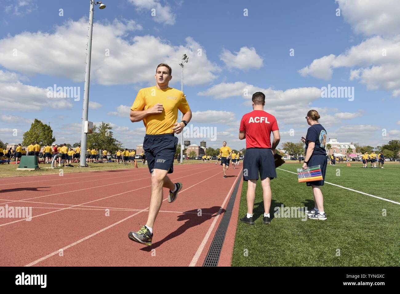 Fla. (Nov. 18, 2016) Seaman Clarke Lange, an information systems technician 'A' school student at  Information Warfare Training Command (IWTC) Corry Station, finishes a 400-meter dash during the command's 'Warrior Day' event. Warrior Day is a series of athletic competitions aimed at promoting resiliency, teamwork and physical fitness among IWTC Corry Station students. Stock Photo