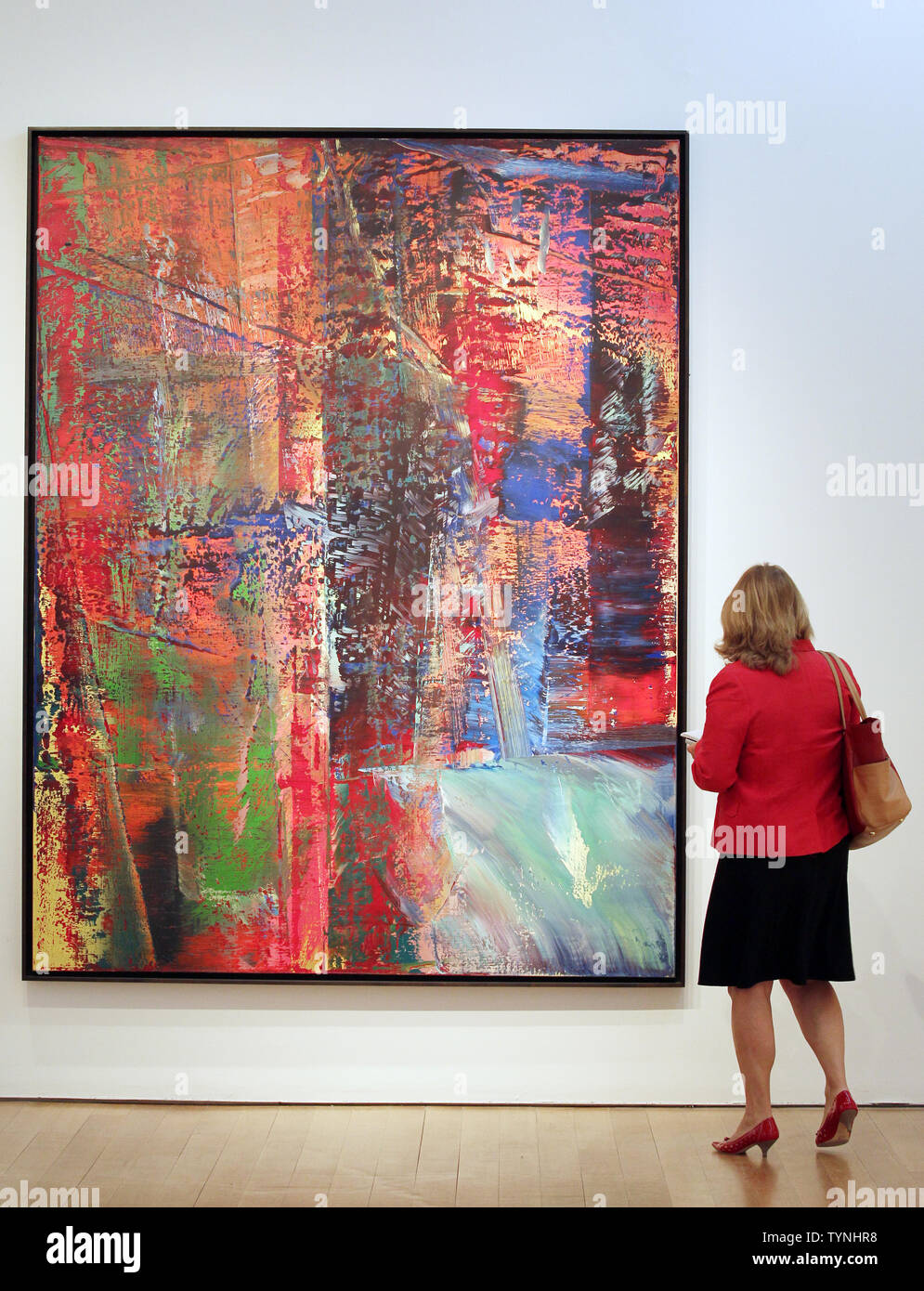 A woman looks at a painting by artist Gerhard Richter titled 'Abstraktes Bild, Dunkel' during a preview of a post-war and contemporary art auction at Christie's in New York City on May 3, 2013. This painting as well as other works of art will be sold at an auction to be held on May 8, 2013.      UPI/John Angelillo Stock Photo