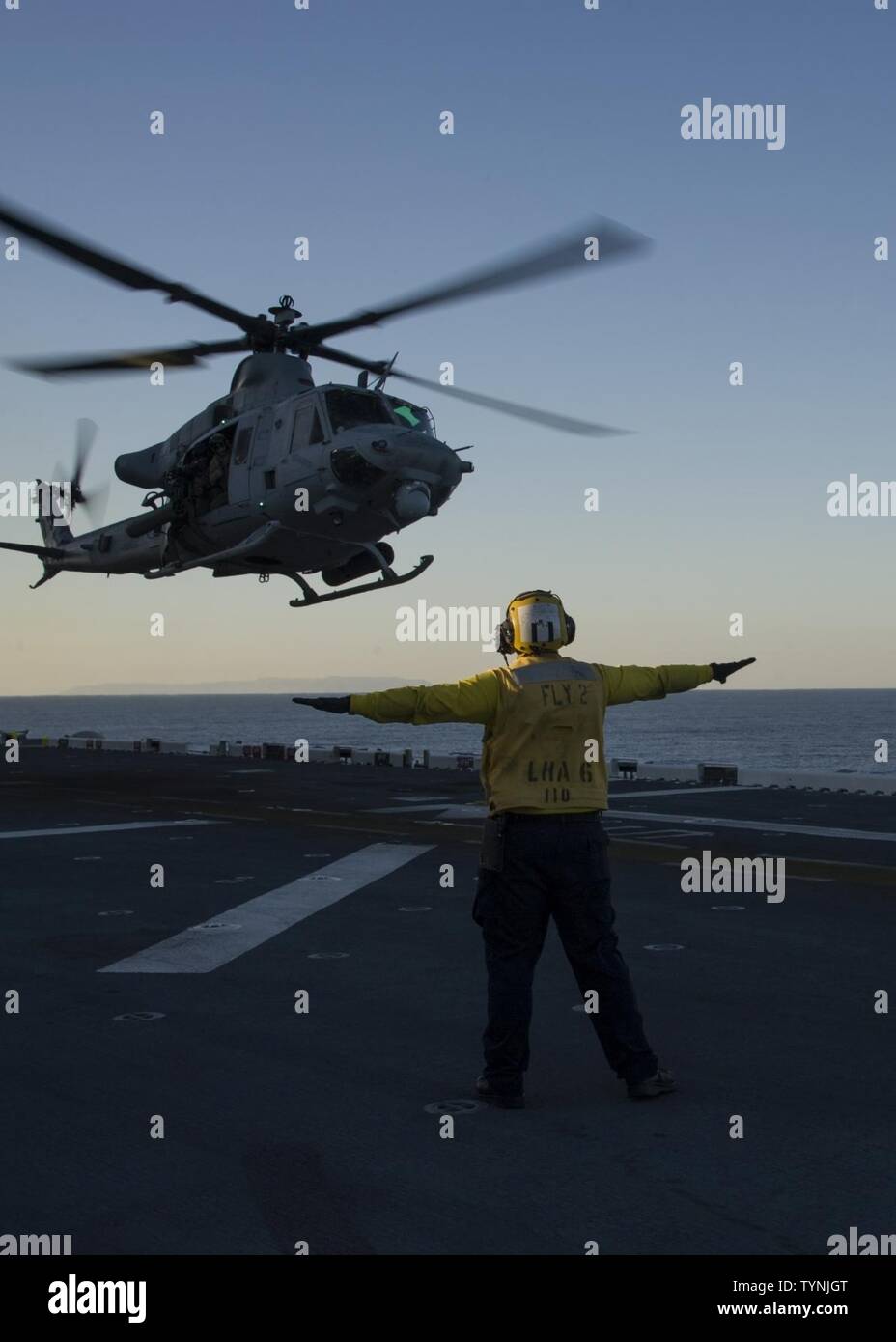 PACIFIC OCEAN (Nov. 17, 2016) A UH-1 Iroquois Helicopter assigned to Marine Operational Test and Evaluation Squadron 1 (VMX-1) lands on the flight deck of amphibious assault ship USS America (LHA 6) as part of the air wing including F-35B Lightning II aircrafts. The F-35B short takeoff/vertical landing (STOVL) variant is the world’s first supersonic STOVL stealth aircraft. America, with VMX-1, Marine Fighter Attack Squadron 211 (VMFA-211) and Air Test and Evaluation Squadron 23 (VX-23) embarked, are underway conducting operational testing and the third phase of developmental testing for the F- Stock Photo
