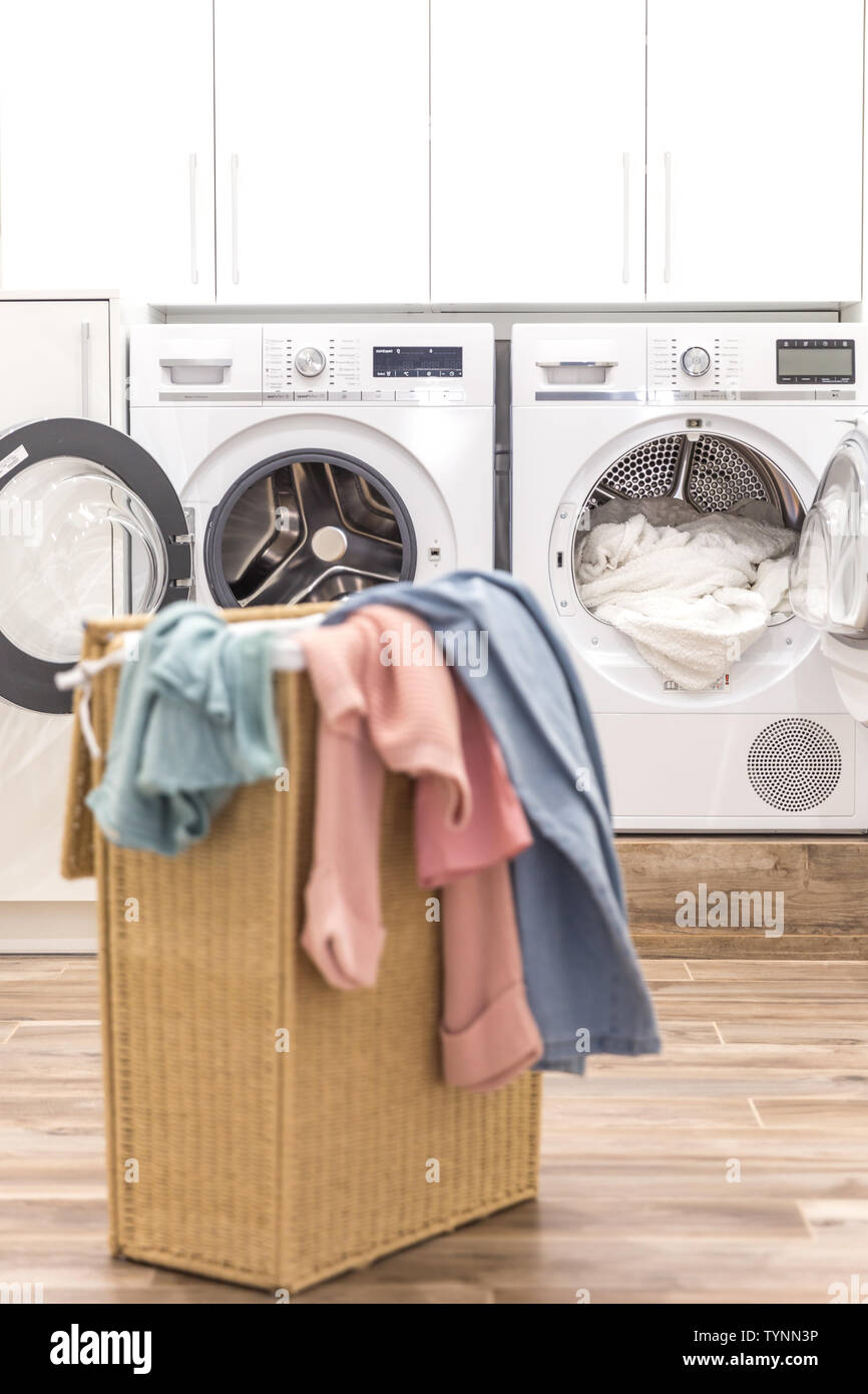 Laundry Basket With Dirty Clothes With Washing And Drying Machines On The Background Stock Photo Alamy