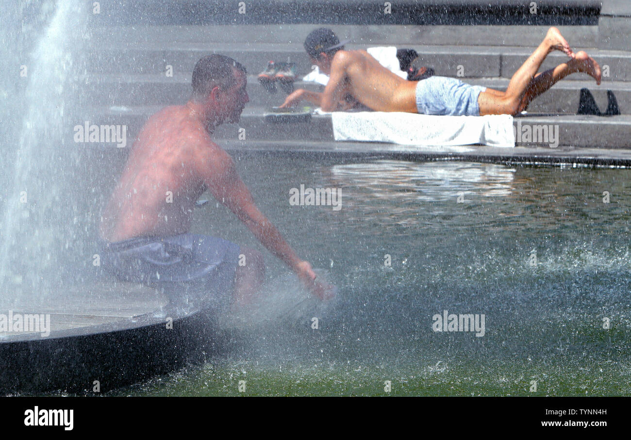 A man keeps cool in the fountain in Washington Square Park as temperatures approach the triple digit mark on July 18, 2013 in New York. People are finding ways to stay cool as heat advisories are in effect while an oppressive heat wave continues across the area.     UPI/Monika Graff Stock Photo