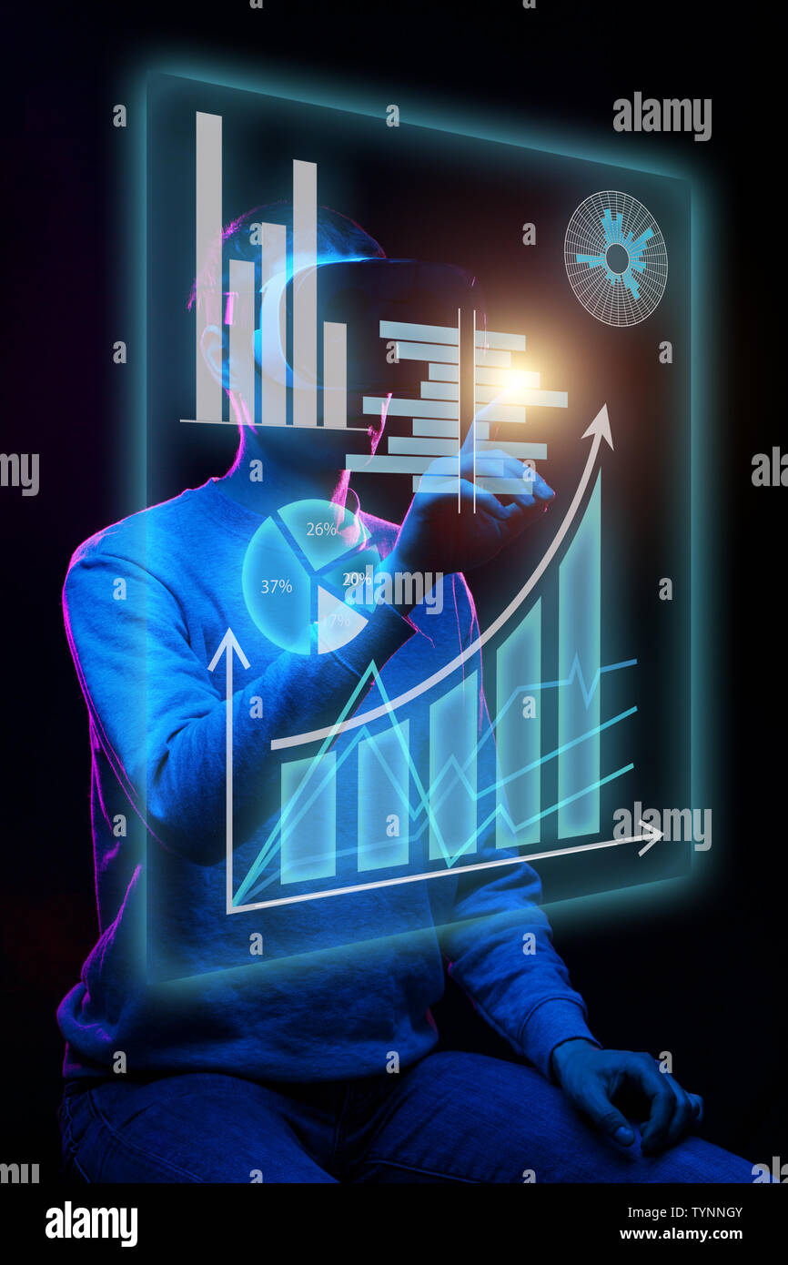 Man uses a virtual reality headset to work with data in the form of ...