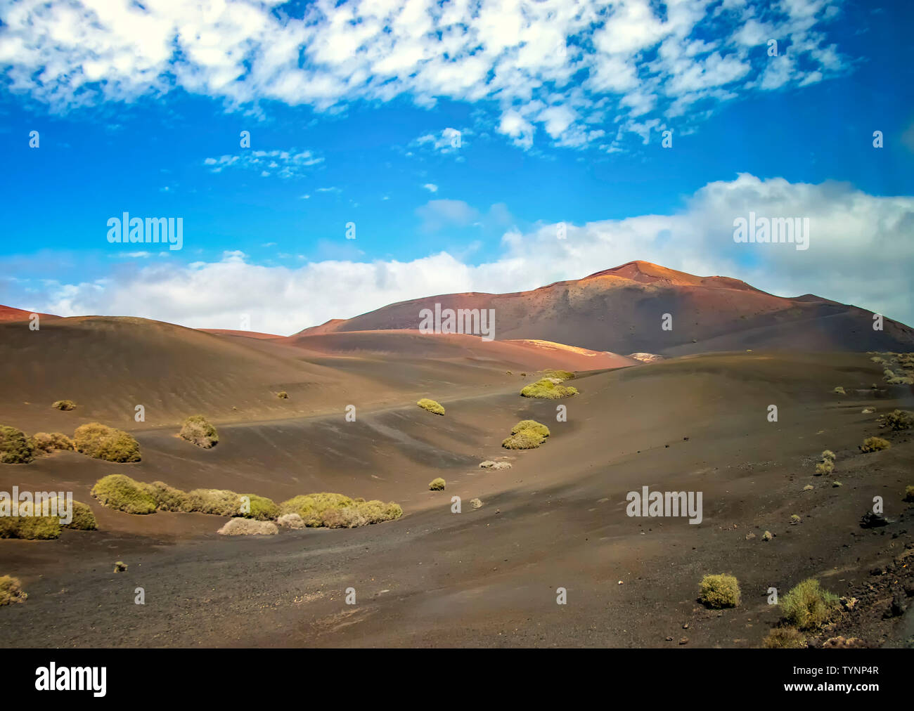 Landscape of Timanfaya National Park in Lanzarote, Canary Islands, Spain. Red and black volcanic mountains. Stock Photo