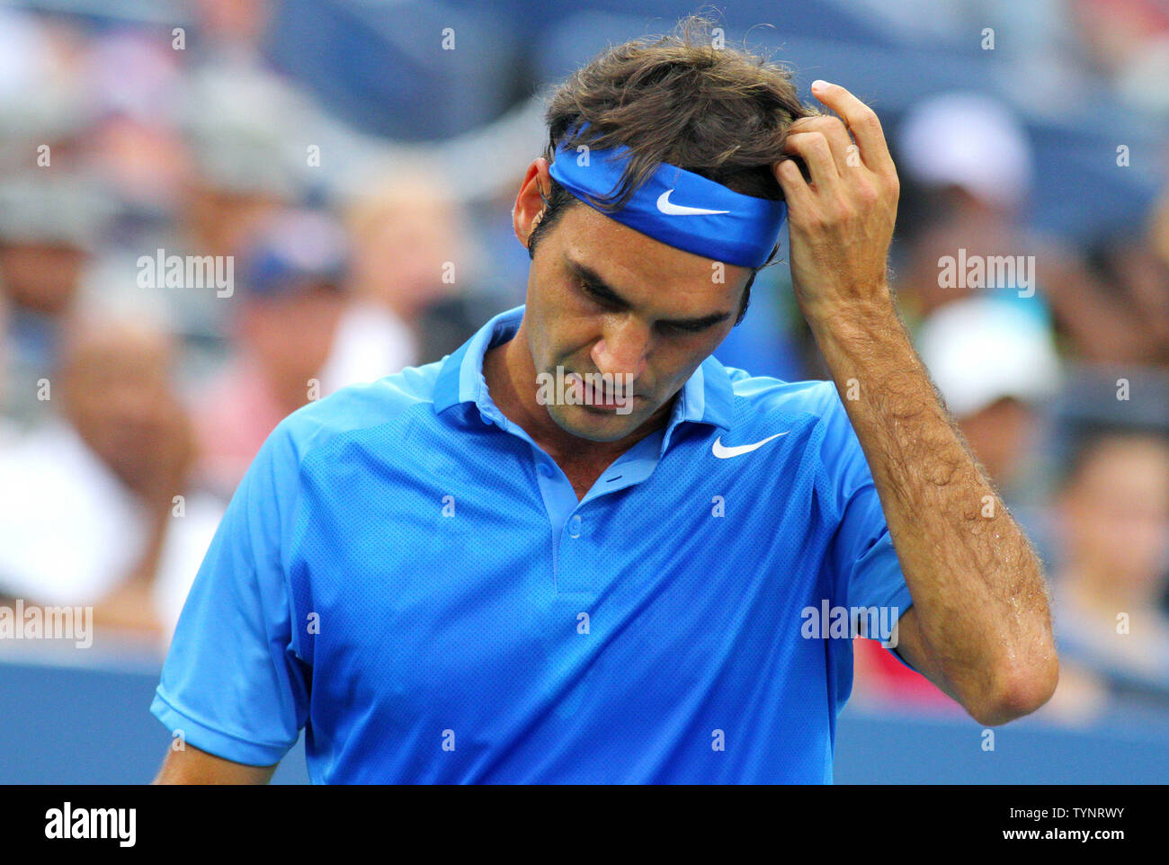 Roger Federer of Switzerland reacts after losing a game to Tommy Robredo of  Spain in the first set of their fourth-round match at the U.S. Open  Championship held at the USTA Billie