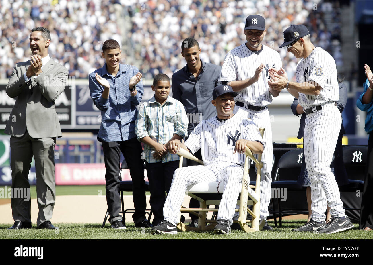 Jorge Posada, Derek Jeter and Joe Girardi react when New York Yankees closer Mariano Rivera sits in a rocking chair on the field when the Yankees honor Mariano Rivera on Mariano Rivera Day before the game against the San Francisco Giants at Yankee Stadium in New York City on September 22, 2013.  Rivera's hall of fame career will end when the Yankees' season does, and every save now could be his last.      UPI//John Angelillo Stock Photo