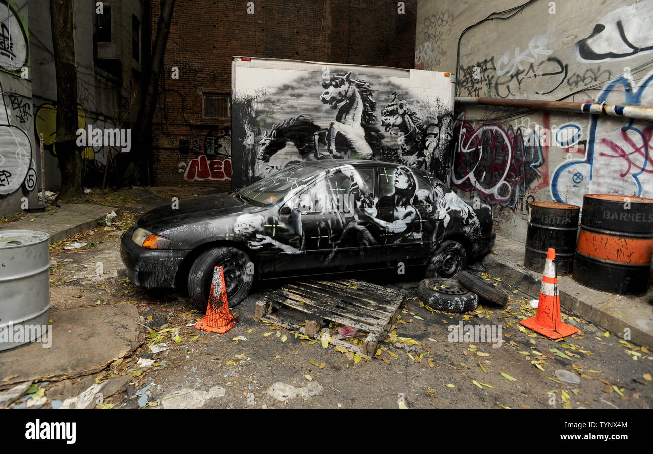 An art work created by British street artist Banksy stands outside in the East Village of Manhattan in New York City in October of 2013. Banksy is a pseudonymous England-based graffiti artist, political activist, film director, and painter. His satirical street art and subversive epigrams combine dark humor with graffiti done in a distinctive stenciling technique.    UPI/Dennis Van Tine Stock Photo