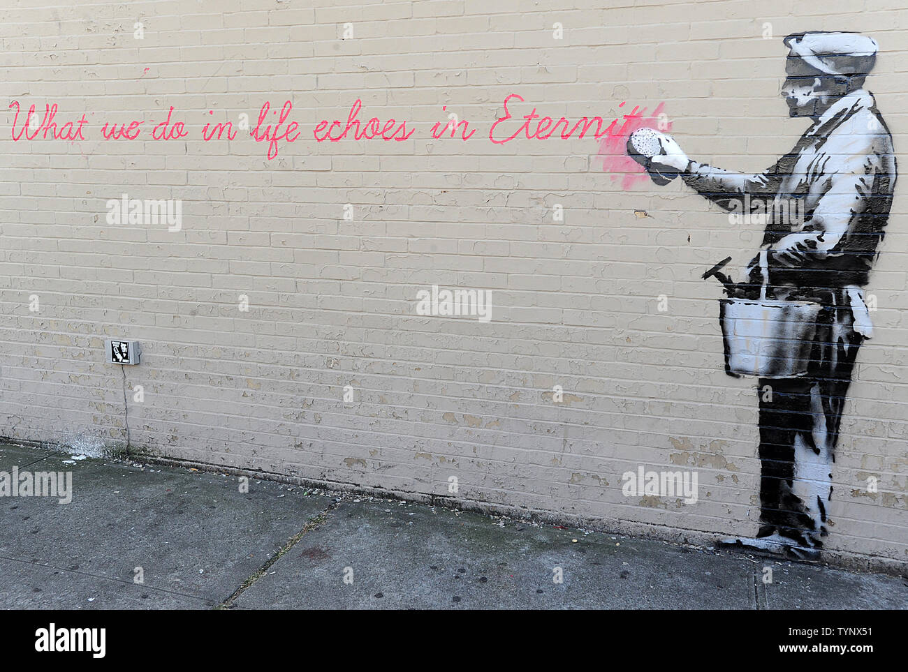 A mural created by British street artist Banksy is seen on a side of a building in Queens in New York City on October 14, 2013. Banksy is a pseudonymous England-based graffiti artist, political activist, film director, and painter. His satirical street art and subversive epigrams combine dark humor with graffiti done in a distinctive stenciling technique.    UPI/Dennis Van Tine Stock Photo