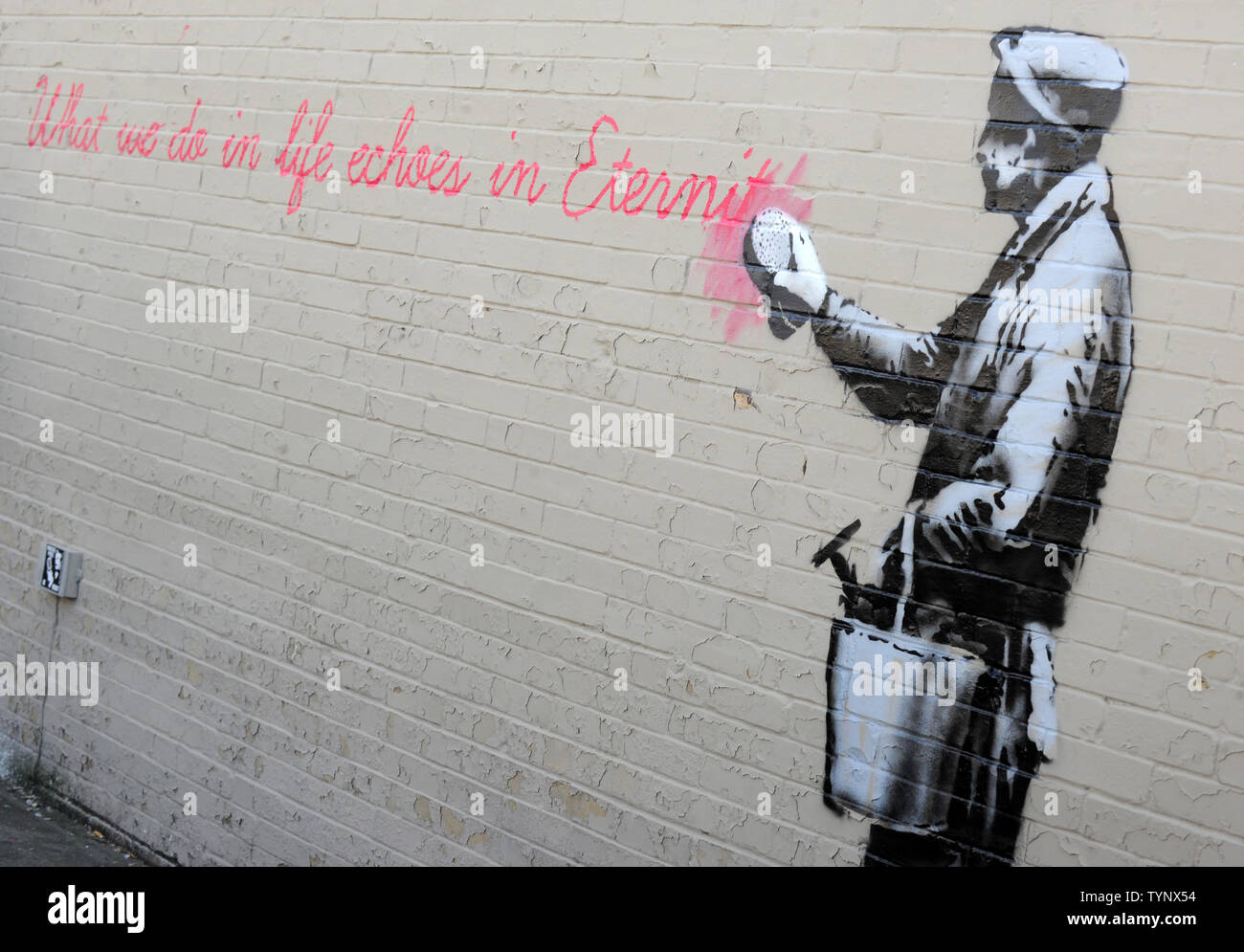 A mural created by British street artist Banksy is seen on a side of a building in Queens in New York City on October 14, 2013. Banksy is a pseudonymous England-based graffiti artist, political activist, film director, and painter. His satirical street art and subversive epigrams combine dark humor with graffiti done in a distinctive stenciling technique.    UPI/Dennis Van Tine Stock Photo