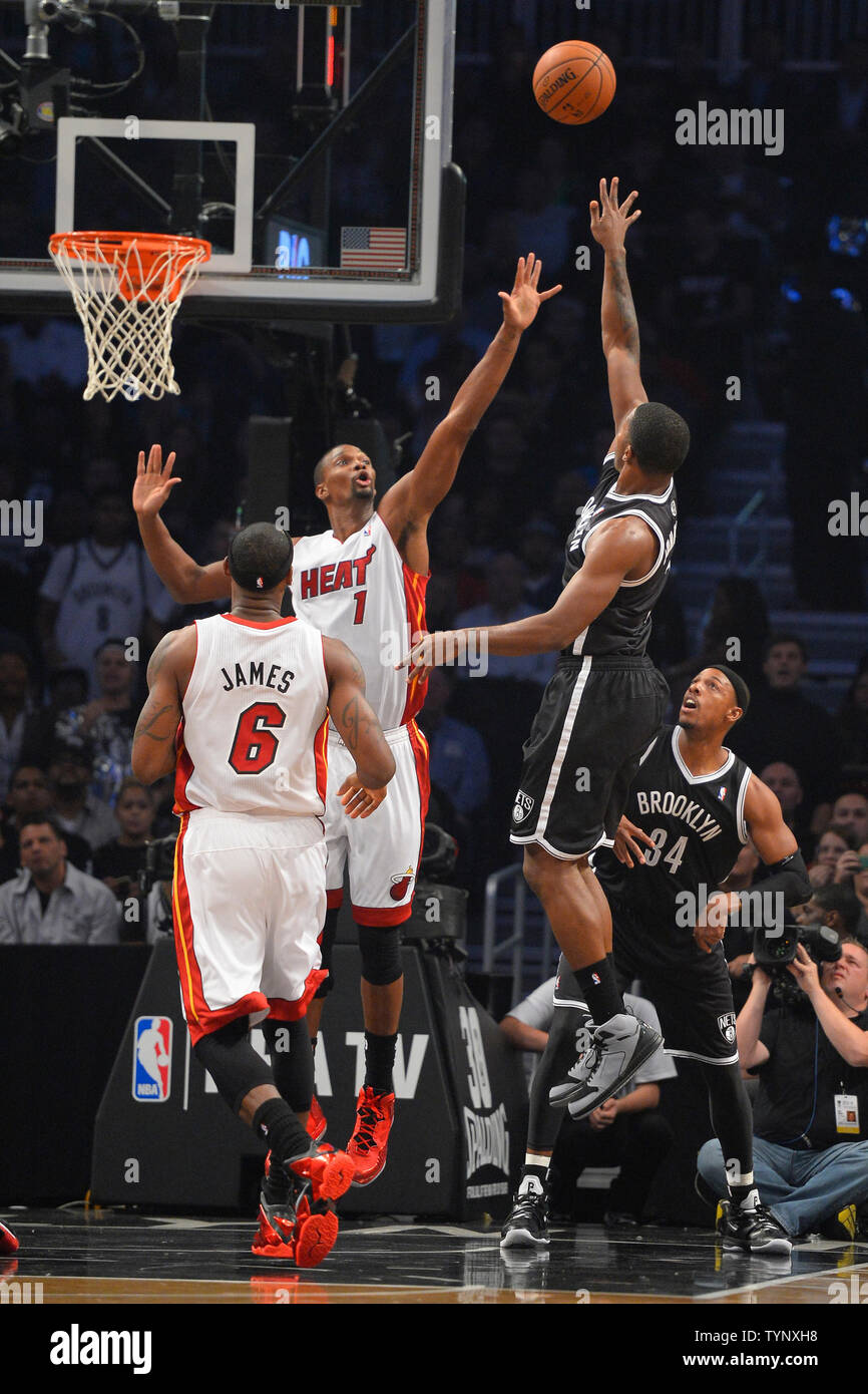 Brooklyn Nets shooting guard Joe Johnson (7) shoots over Miami Heat center Chris Bosh (1) and Heat small forward LeBron James (6) during the first quarter at Barclays Center in New York City on November 1, 2013.   UPI/Rich Kane Stock Photo