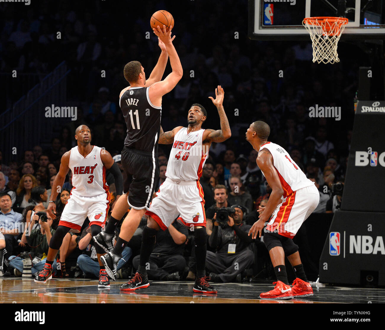 Brooklyn Nets center Brook Lopez (11) shoots over Miami Heat power forward Udonis Haslem (40), Heat shooting guard Dwyane Wade (3) and Heat center Chris Bosh (1) in the first quarter at Barclays Center in New York City on November 1, 2013.   UPI/Rich Kane Stock Photo