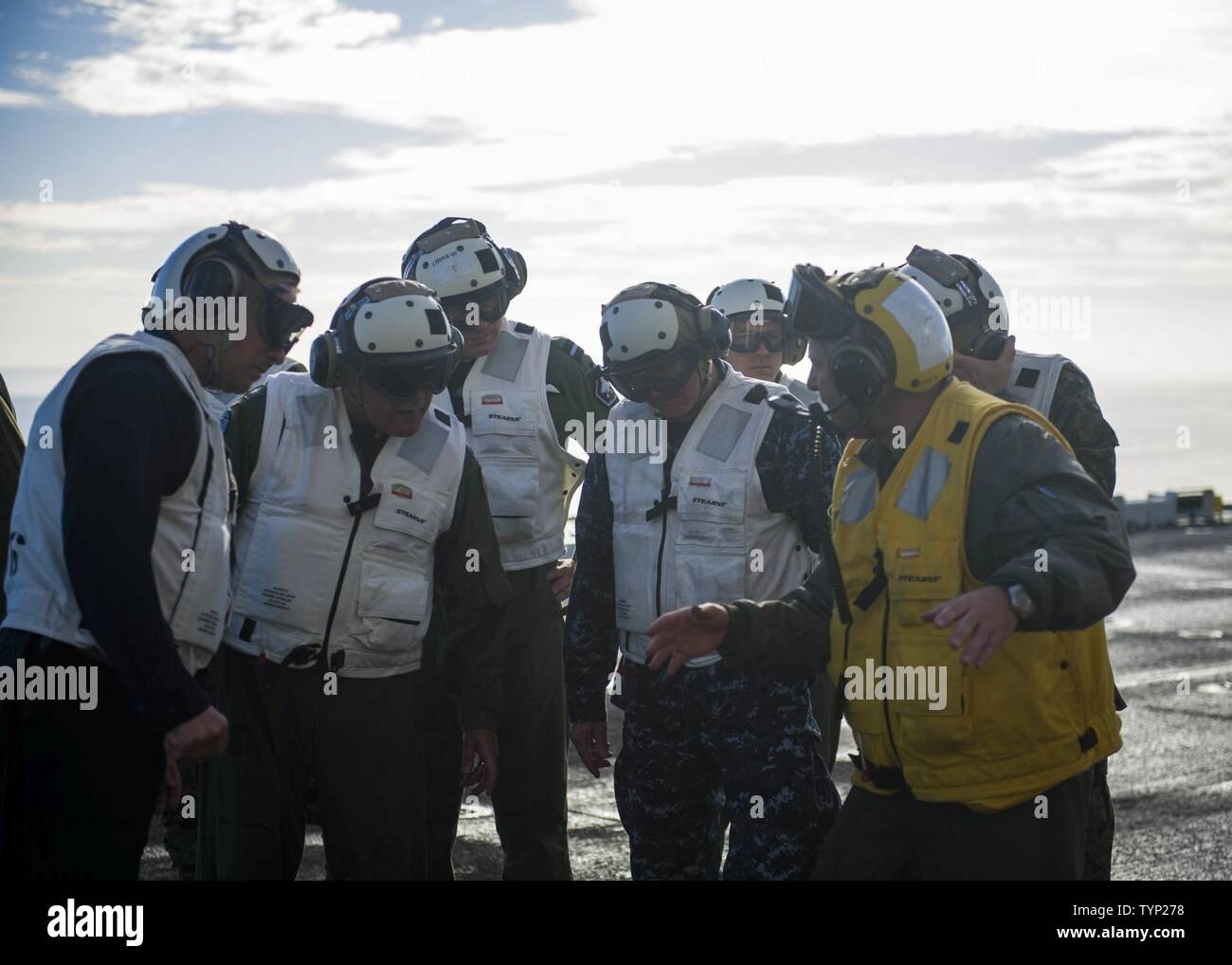 PACIFIC OCEAN (Nov. 19, 2016)  Vice Adm. Thomas Rowden , Commander, Naval Surface Forces Pacific, and Rear Adm. Dan Fillion, Commander, Expeditionary Strike Group 3, tour the flight deck of amphibious assault ship USS America (LHA 6) with the ship’s commanding officer Capt. Joe Olson, during the third phase of developmental testing (DT-III) for the F-35B Lighting II aircraft. The F-35B short takeoff/vertical landing (STOVL) variant is the world’s first supersonic STOVL stealth aircraft. America, with VMX-1, Marine Fighter Attack Squadron 211 (VMFA-211) and Air Test and Evaluation Squadron 23 ( Stock Photo