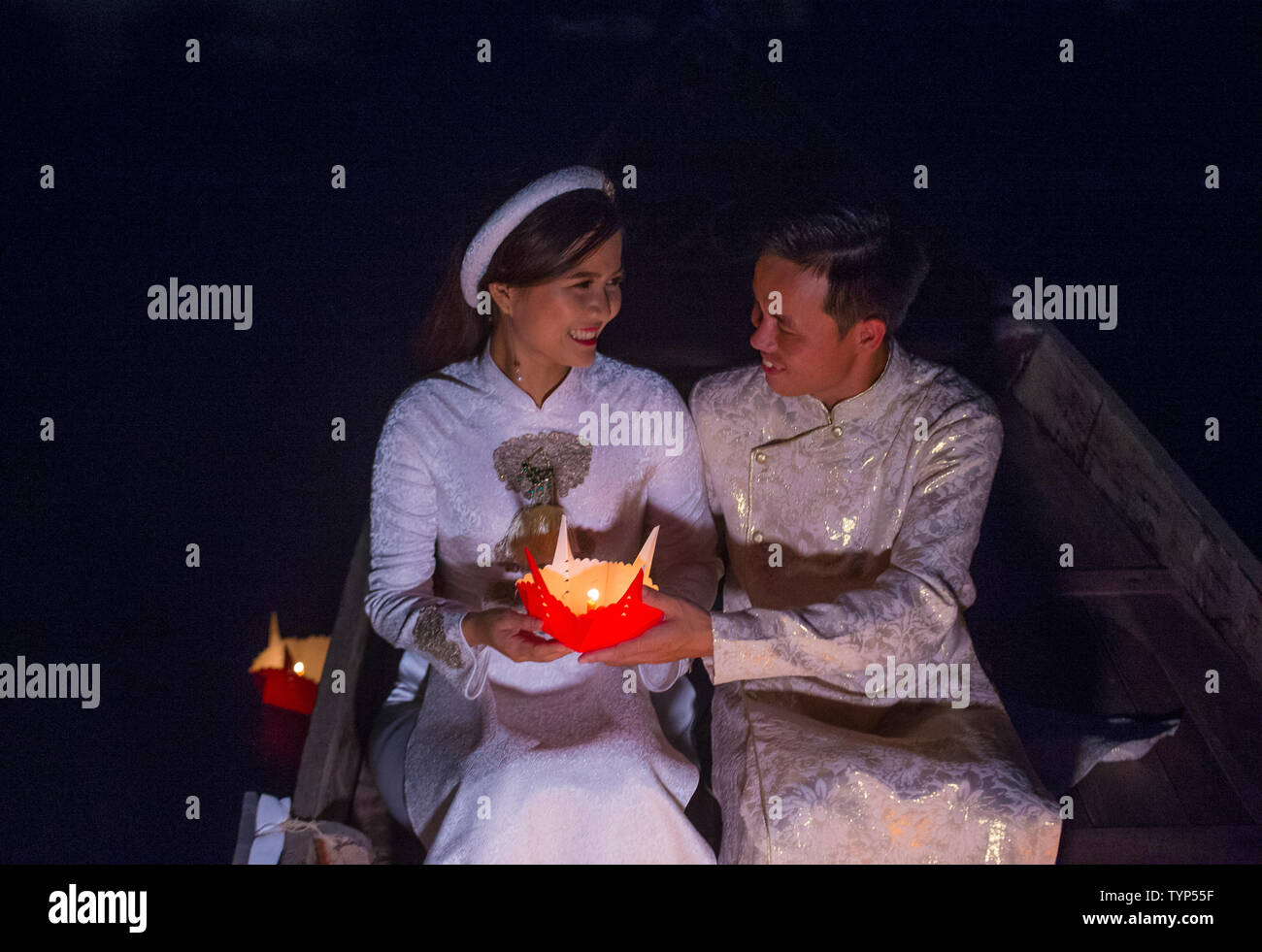 Vietnamese couple holding lanterns before droping them into the river in Hoi An ,Vietnam during the Hoi An Full Moon Lantern Festival Stock Photo