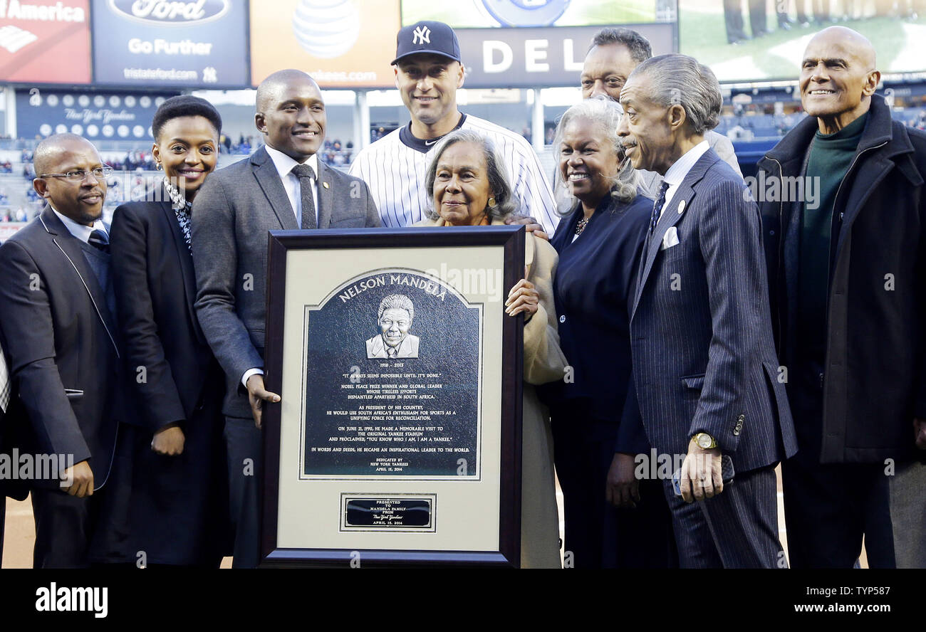 Sello Hartang, CEO of the Nelson Madela Foundation, Mrs. Lindo Mandela and Mr. Zondwa Mandela, grandson of Nelson Madela,  New York Yankees' Derek Jeter, Mrs Rachel Robinson, widow of Jackie Robinson, Rev. Jesse Jackson, Sharon Robinson, daughter of Jackie and Rachel Robinson, Rev. Al Sharpton and singer Harry Belafonte stand on the field with a framed plaque after a plaque is unveiled in Monument Park honoring the late South African President Nelson Mandela on Jackie Robinson Day in game 2 of a double header against the Chicago Cubs at Yankee Stadium in New York City on April 16, 2014. UPI/Jo Stock Photo