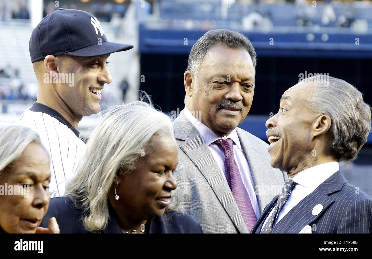 New York Yankees Derek Jeter exchanges words with Rev. Al Sharpton and Rev. Jesse Jackson on the field after a plaque is unveiled in Monument Park honoring the late South African President Nelson Mandela on Jackie Robinson Day in game 2 of a double header against the Chicago Cubs at Yankee Stadium in New York City on April 16, 2014. UPI/John Angelillo Stock Photo