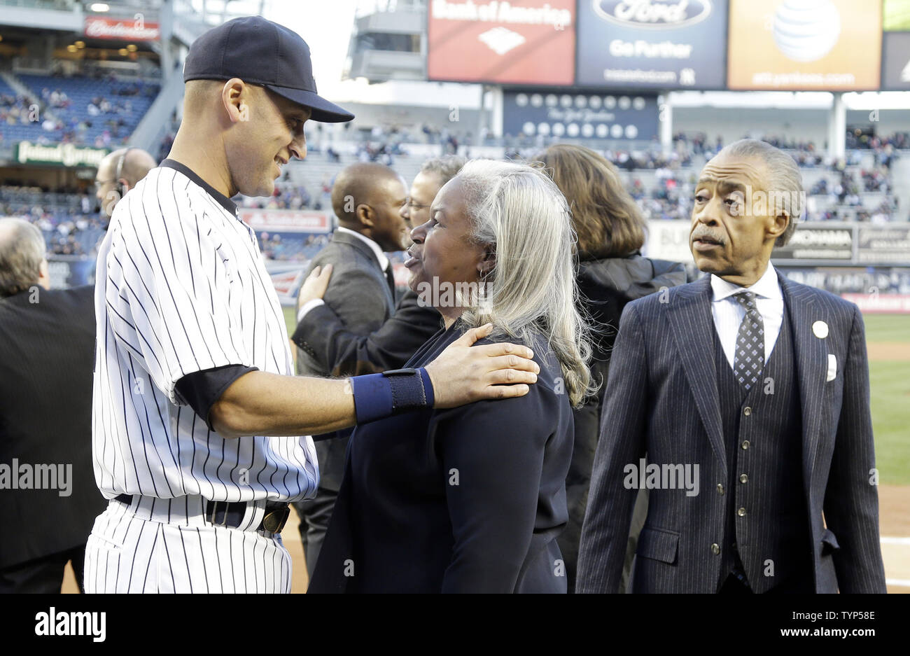 Rev. Al Sharpton watches New York Yankees Derek Jeter exchange words with Sharon Robinson on the field after a plaque is unveiled in Monument Park honoring the late South African President Nelson Mandela on Jackie Robinson Day in game 2 of a double header against the Chicago Cubs at Yankee Stadium in New York City on April 16, 2014. UPI/John Angelillo Stock Photo