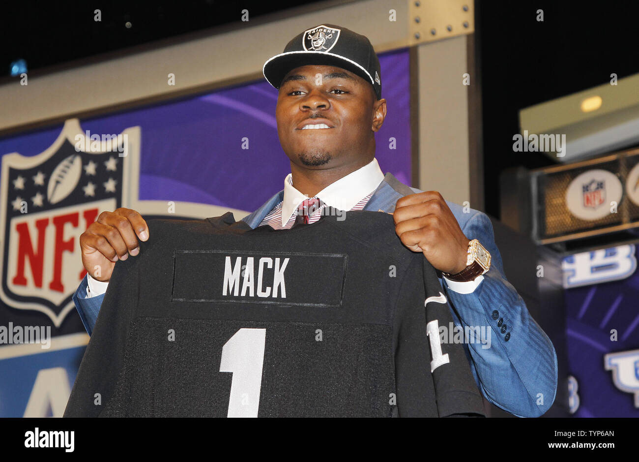 Buffalo linebacker Khalil Mack stands on the stage after the Oakland  Raiders select him with the 35 overall pick in the first round at the 2014  NFL Draft at Radio City Music, image size:1300x939