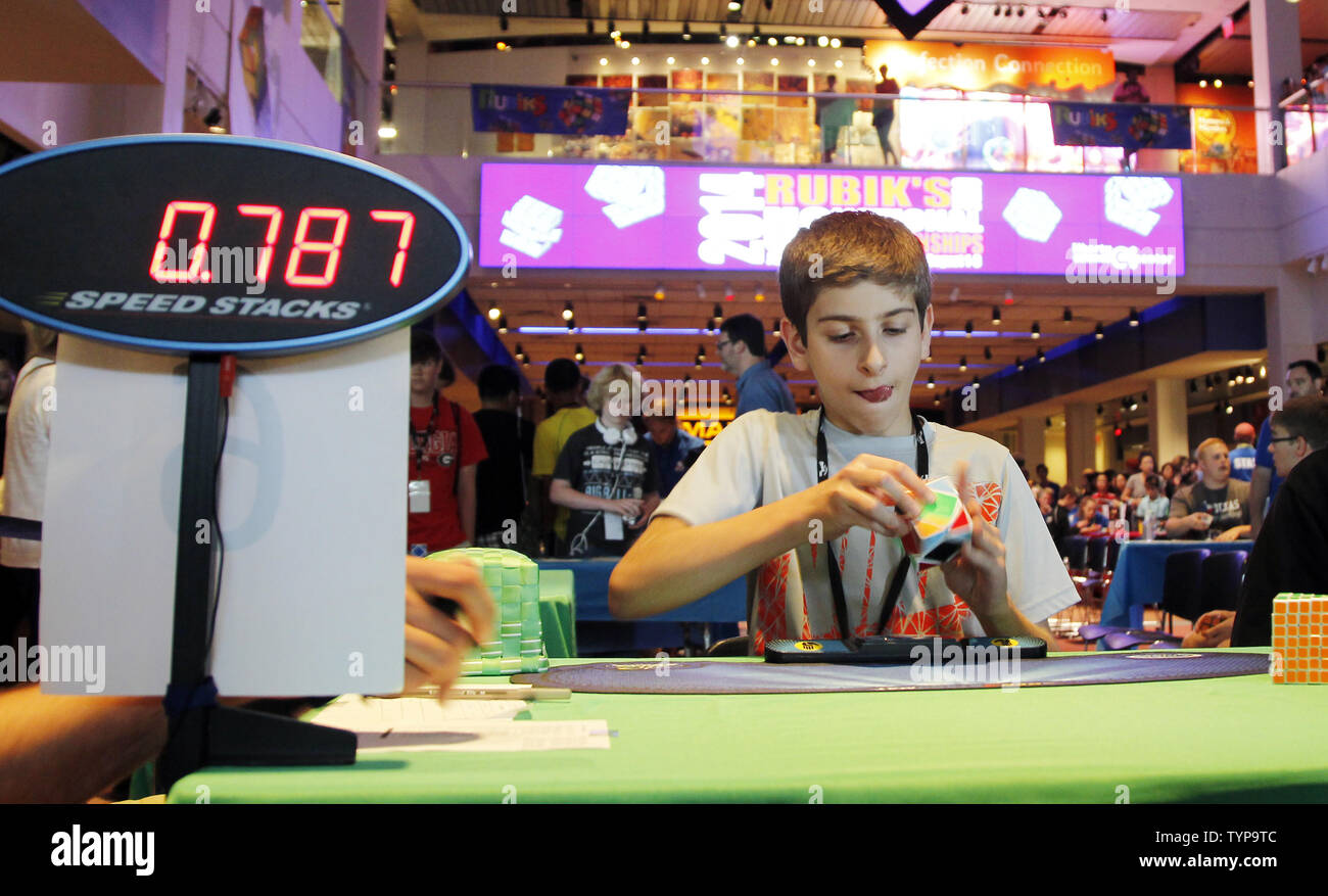 A boy competes at the National Rubik's Cube Championship at Liberty Science Center in Jersey City, NJ on August 1, 2014. The Championship and the Guinness Book of World Records challenge are being held in conjunction with the Center's Beyond Rubik's Cube exhibition, marking the 40th anniversary of the Rubik's Cube and its impact on the world.        UPI/John Angelillo Stock Photo