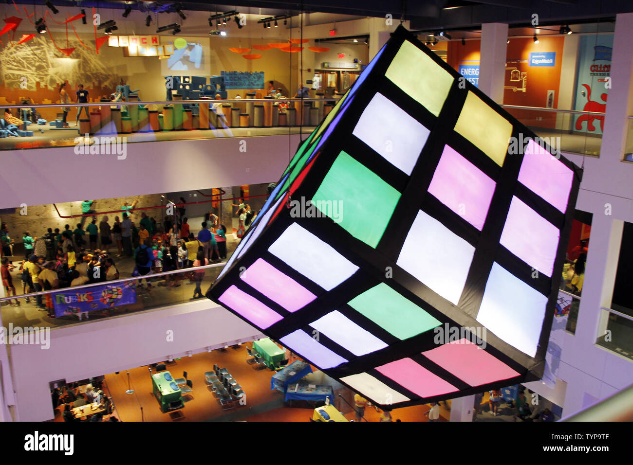 People walk through a Rubik's Cube Exhibit at the National Rubik's Cube Championship at Liberty Science Center in Jersey City, NJ on August 1, 2014. The Championship and the Guinness Book of World Records challenge are being held in conjunction with the Center's Beyond Rubik's Cube exhibition, marking the 40th anniversary of the Rubik's Cube and its impact on the world.        UPI/John Angelillo Stock Photo