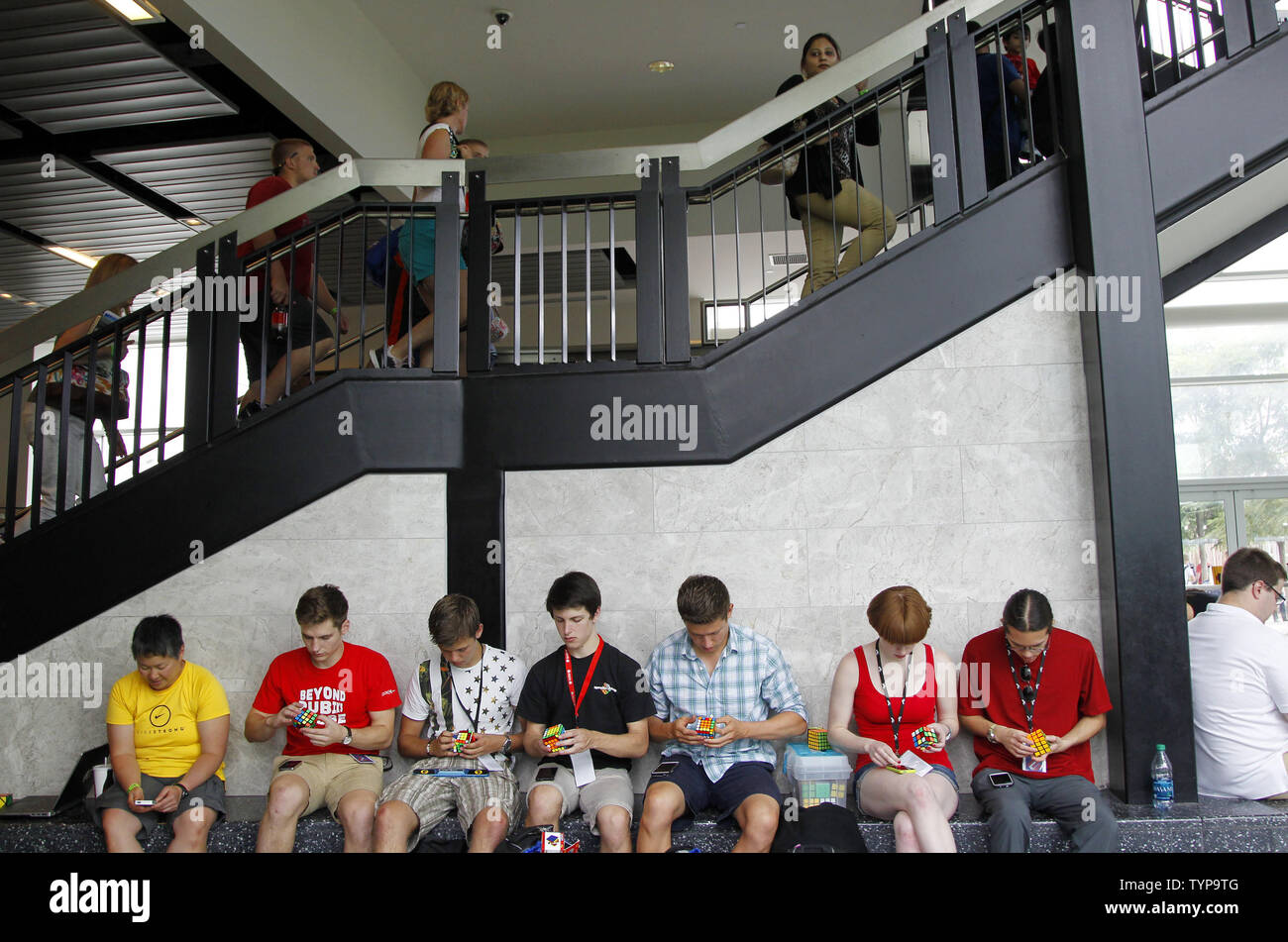 Contestants practice and warm up before competing at the National Rubik's Cube Championship at Liberty Science Center in Jersey City, NJ on August 1, 2014. The Championship and the Guinness Book of World Records challenge are being held in conjunction with the Center's Beyond Rubik's Cube exhibition, marking the 40th anniversary of the Rubik's Cube and its impact on the world.        UPI/John Angelillo Stock Photo